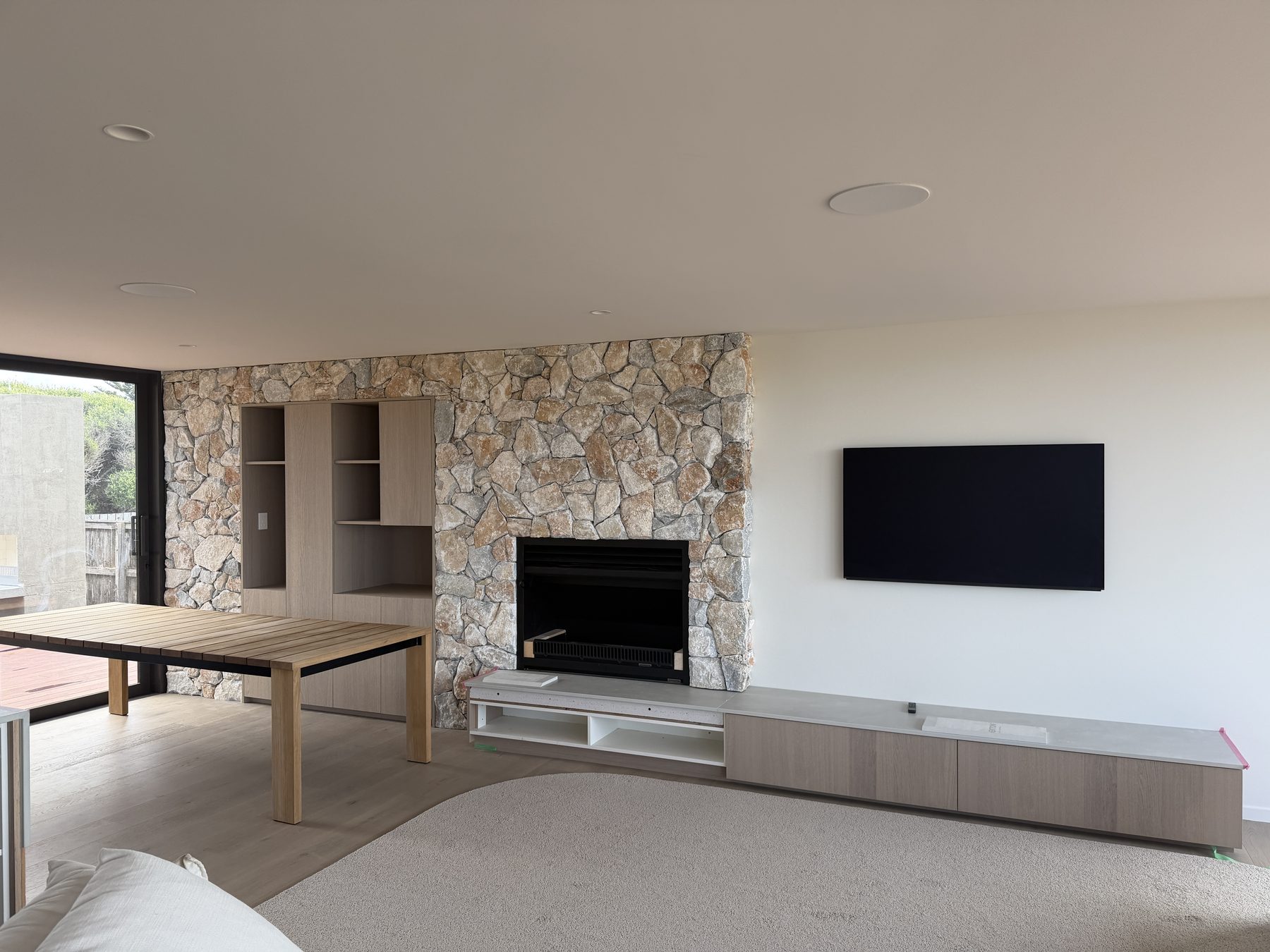 Natural stone feature fireplace wall in a coastal living room